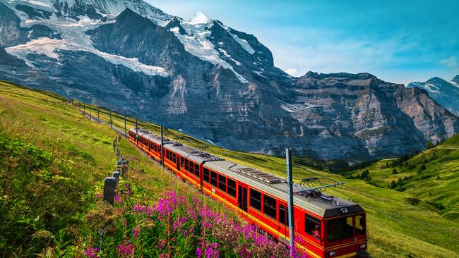 Cogwheel railway with electric red tourist train. Grindelwald, Bernese Oberland.