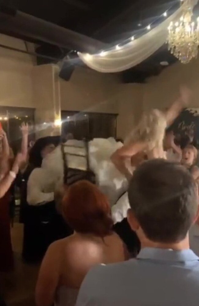 She came crashing down when the guests lifted her chair. Picture: TikTok/nicloespinder1