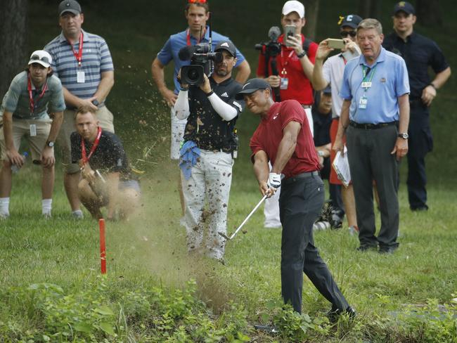 Tiger Woods hits his second shot from the rough on the 17th hole during the final round of the PGA Championship golf tournament at Bellerive Country Club, Sunday, Aug. 12, 2018, in St. Louis. (AP Photo/Charlie Riedel)