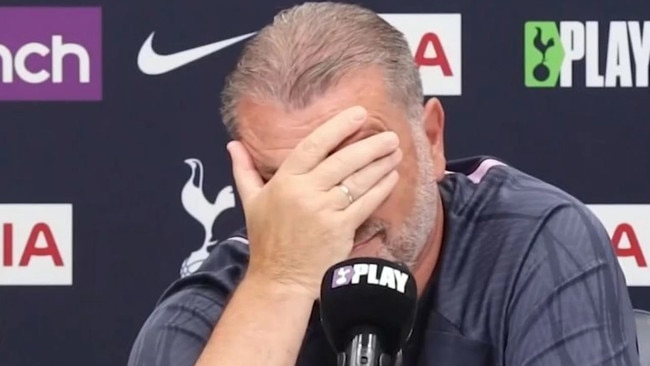 Ange Postecoglou shakes his head as he faces the press.