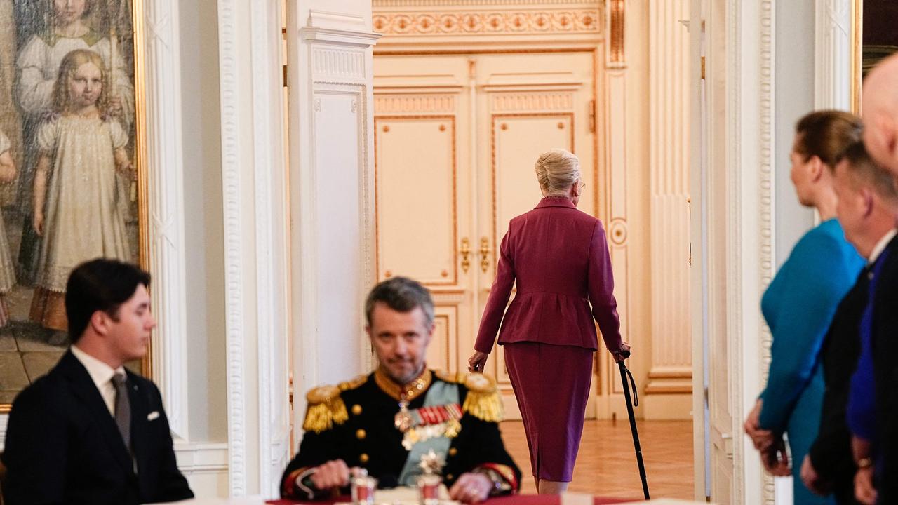 After signing the declaration of abdication Queen Margrethe II of Denmark leaves the seat at the head of the table to her son King Frederik X of Denmark as Prince Christian of Denmark (L) and Danish Prime Minister Mette Frederiksen (R) react during the meeting of the Council of State at the Christiansborg Castle in Copenhagen, Denmark. Picture: AFP)