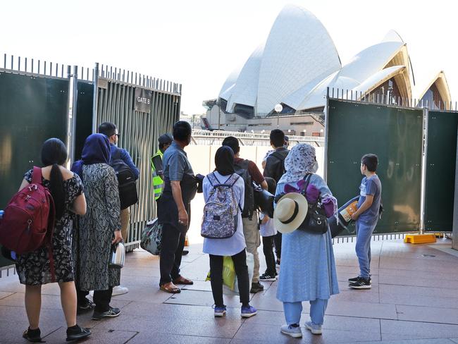 Security turning away members of the public who were not ticketed at Circular Quay on the morning of New Year’s Eve 2021. The area would normally be packed with early birds looking to get a good spot for the fireworks, but officials brought in a system of tickets to control numbers. Picture: Richard Dobson