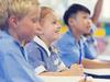 Generic photo of happy students in their classroom wearing their school uniform