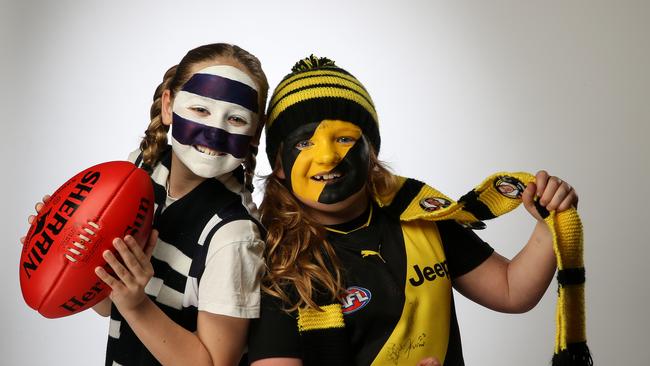 Richmond fan Eliza – pictured with Geelong follower Georgie – is likely hoping for another Grand Final flag. Picture: Tim Carrafa