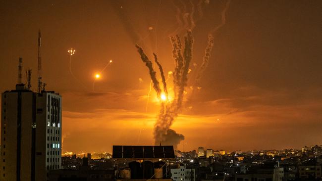 Rockets launched towards Israel from the northern Gaza Strip and response from the Israeli missile defence system known as the Iron Dome leave streaks through the sky on May 13. Picture: Fatima Shbair/Getty Images