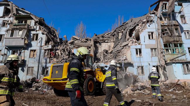 Ukrainian rescuers work on the five-storey residential building destroyed after a missile strike in Zaporizhzhia in March. Picture: AFP