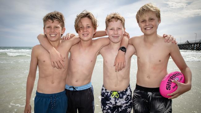 Young mates Zac, Jack, Harry and Hugo have some out-of-school beach fun at Henley. Picture: Emma Brasier