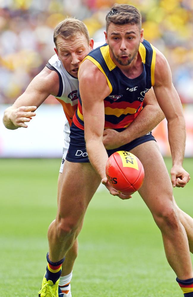 Rory Atkins gets his handball away, despite pressure from GWS veteran Steve Johnson. Picture: Tom Huntley