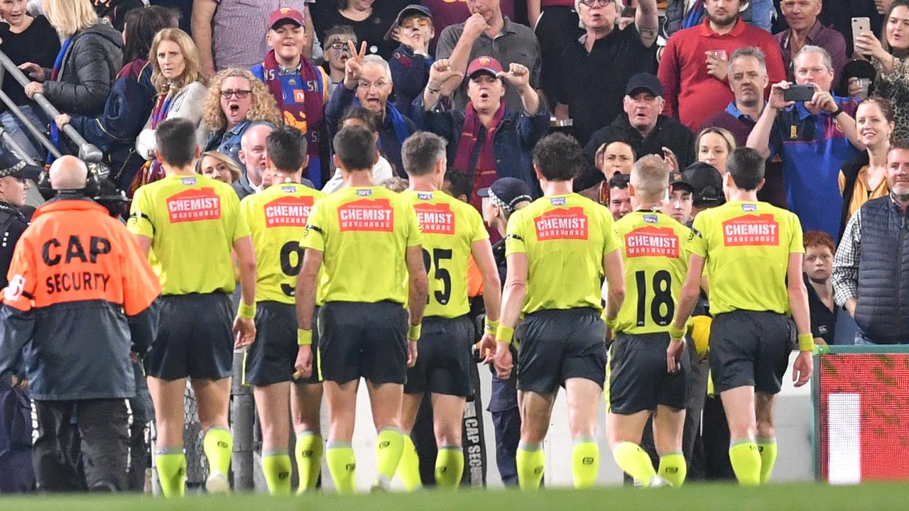 The crowd is seen booing the umpires as they leave the field at half-time during the Lions-Giants final.