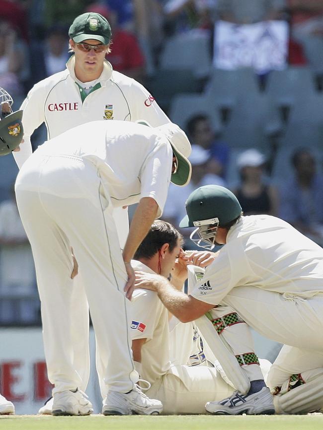 Justin Langer is helped by teammate Matthew Hayden after being struck in the head by a delivery from Makhaya Ntini of South Africa at the Wanderers Stadium in 2006. Picture: Getty Images