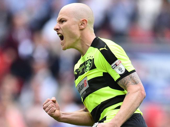 Huddersfield Town's Australian midfielder Aaron Mooy celebrates after scoring his penalty in the shoot-out during the English Championship play-off final football match between Huddersfield Town and Reading at Wembley Stadium in London on May 29, 2017. Huddersfield won the penalty shoot-out 4-3 after the game finished 0-0 after extra time.  / AFP PHOTO / Glyn KIRK / NOT FOR MARKETING OR ADVERTISING USE / RESTRICTED TO EDITORIAL USE