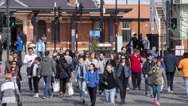 Pedestrians cross Maroondah Highway from Ringwood railway station into Ringwood Town Square. Picture: Andy Brownbill