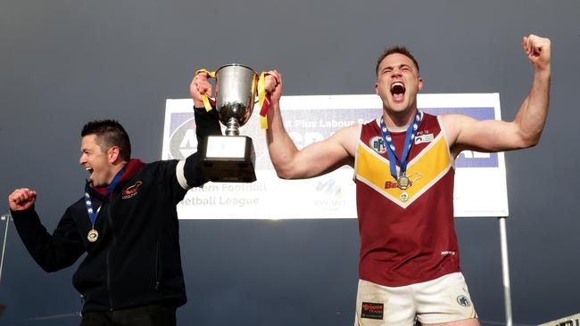 Lower Plenty coach Ben Turner and captain Patrick Flynn celebrate with the premiership cup. Picture: Mark Dadswell.