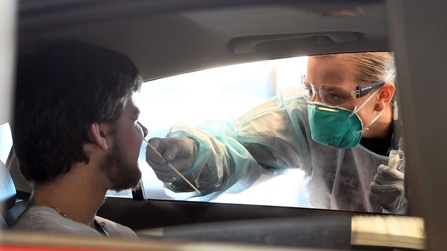 A member of the Australian Defence Force takes a swab for a coronavirus test from a member of the public in Melbourne. Picture: William West/AFP