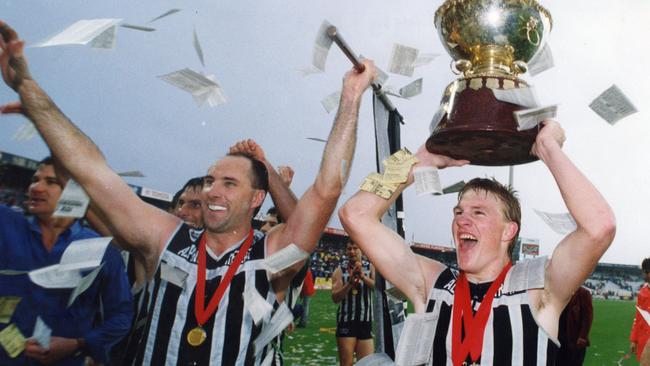 Nathan Buckley, right, with Roger Delaney and the Thomas Seymour Hill trophy after Port Adelaide beat Glenelg in the 1992 SANFL grand final. 