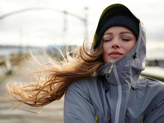 Shoot of young beautiful woman wearing rain jacket in cold weather
