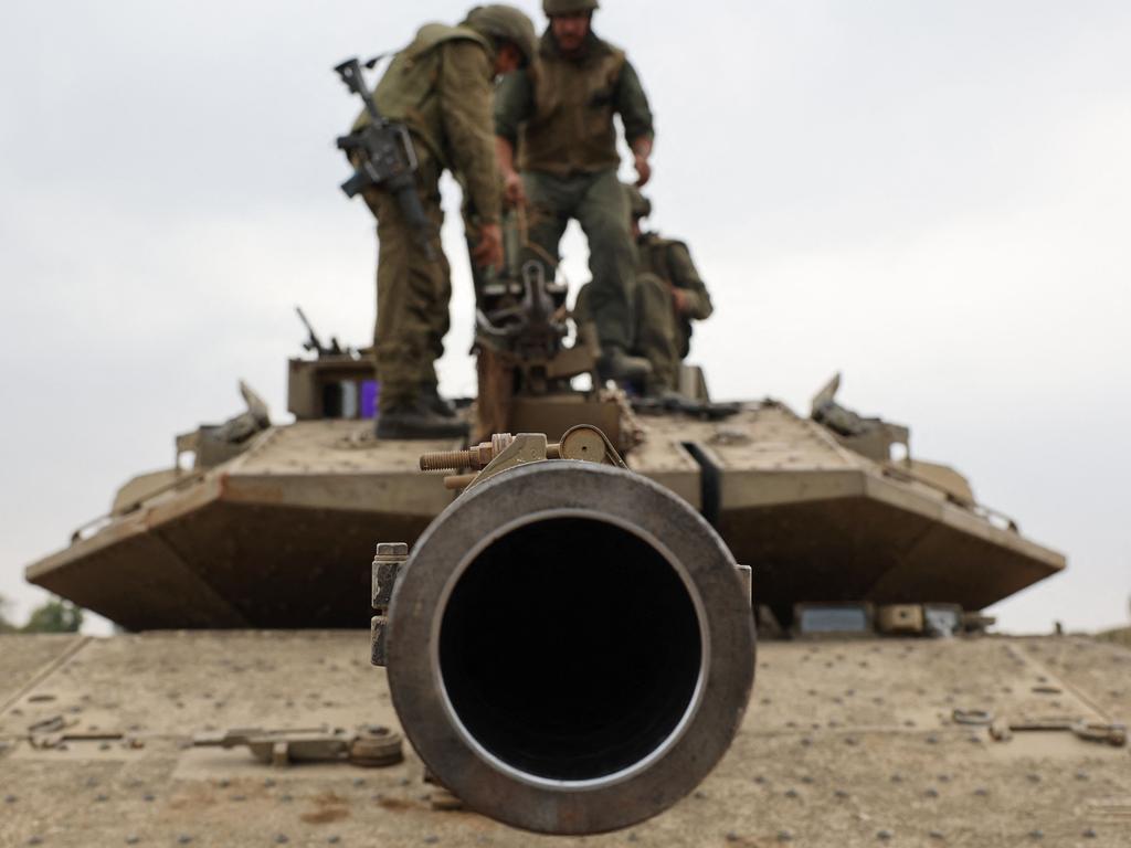 Israeli army soldiers positioned with their Merkava tanks near the border with the Gaza Strip in southern Israel. Picture: AFP