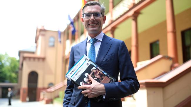 NSW Treasurer Dominic Perrottet with the freshly printed 2020-21 NSW Budget Papers at Parliament House. Picture: NCA NewsWire / Christian Gilles