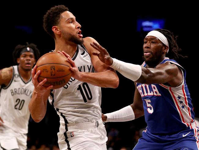 NEW YORK, NEW YORK - OCTOBER 03:  Ben Simmons #10 of the Brooklyn Nets tries to keep the ball from Montrezl Harrell #5 of the Philadelphia 76ers in the first half during a preseason game at Barclays Center on October 03, 2022 in the Brooklyn borough of New York City. NOTE TO USER: User expressly acknowledges and agrees that, by downloading and or using this photograph, User is consenting to the terms and conditions of the Getty Images License Agreement. (Photo by Elsa/Getty Images)