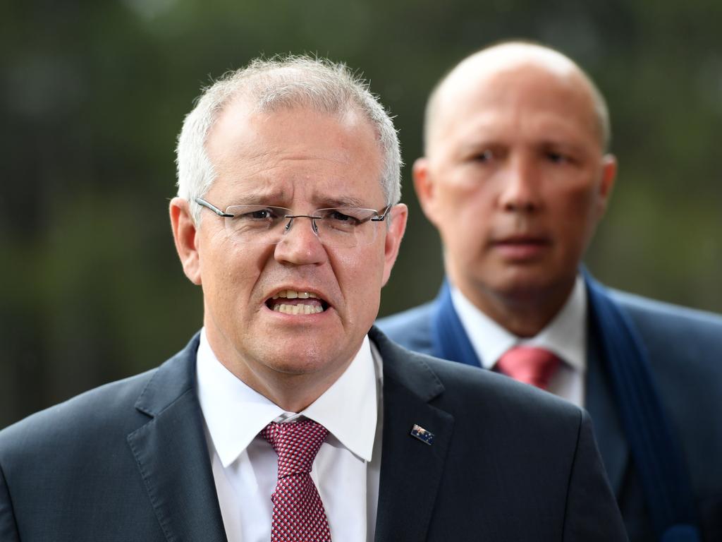 Australian Prime Minister Scott Morrison (left), watched by Minister for Home Affairs Peter Dutton. Picture: Dan Peled