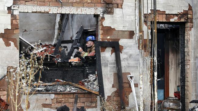 Fire investigators at the home in Grange, which was destroyed by the fire. Picture: Dean Martin / AAP