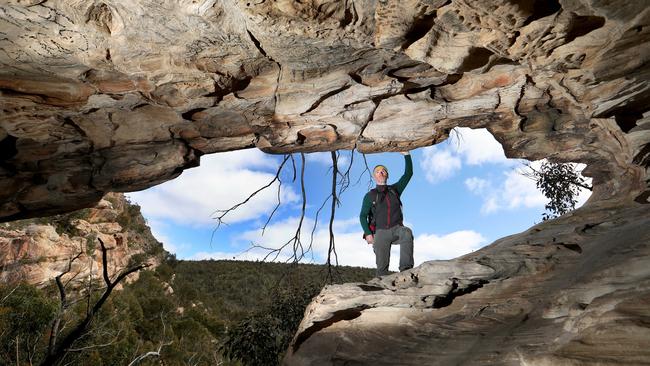 Climber Mark Wood at an area damaged by graffiti at Beehive Falls in the Grampians. Picture: David Geraghty