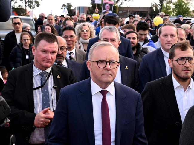 Australia's Prime Minister Anthony Albanese (C) walks with members of the Melbourne Jewish community during a vigil held on the first anniversary of the Israel-Hamas conflict, in Melbourne on October 7, 2024. (Photo by William WEST / AFP)