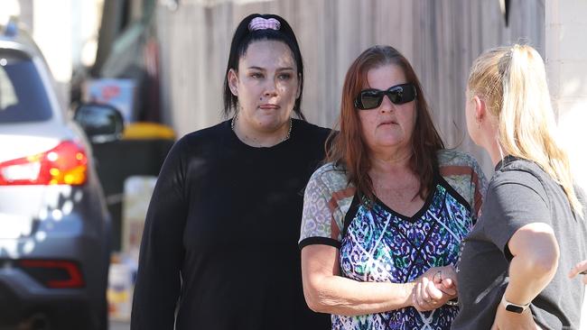 The boy’s grandmother (centre) and aunt (right) at the Deception Bay residence. Picture: Liam Kidston