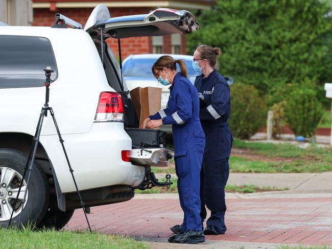 Forensic teams bag evidence from the home. Picture: Brendan Beckett