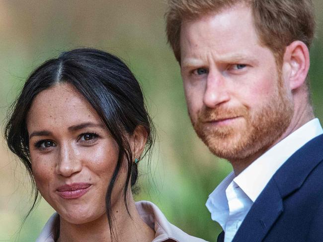 Britain's Prince Harry, Duke of Sussex(R) and Meghan, the Duchess of Sussex(L) arrive at the British High Commissioner residency in Johannesburg where they  will meet with Graca Machel, widow of former South African president Nelson Mandela, in Johannesburg, on October 2, 2019. - Prince Harry recalled the hounding of his late mother Diana to denounce media treatment of his wife Meghan Markle, as the couple launched legal action against a British tabloid for invasion of privacy. (Photo by Michele Spatari / AFP)