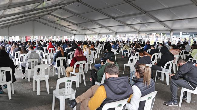 Hundreds of people waiting to receive their Covid-19 vaccinations at the Sydney Olympic Park hub in Homebush on Sunday. Picture: Richard Dobson