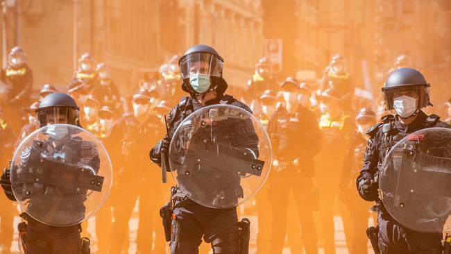 Freedom Rally protesters throw flares and glass bottles. Picture: NCA NewsWire/Sarah Matray