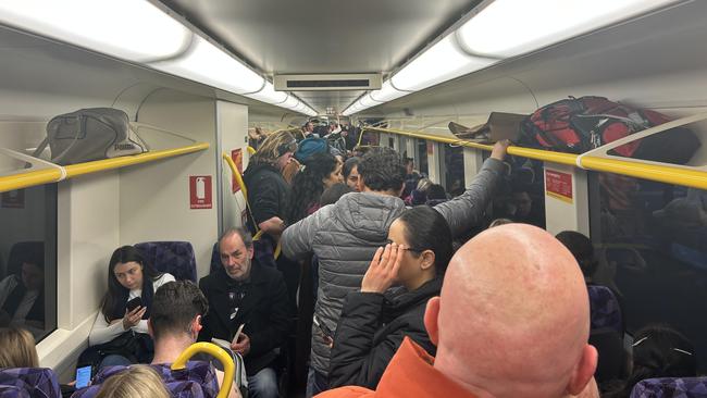 Passengers on a train leaving Southern Cross following a game at Marvel Stadium on August 6