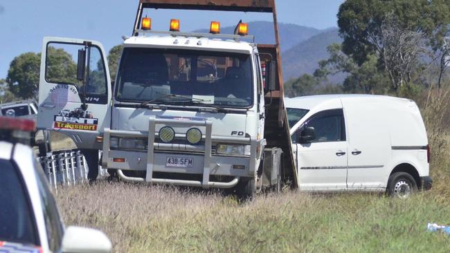 A tow truck moves a van from the scene of a fatal crash on the Bruce Highway near Bowen where a woman died.