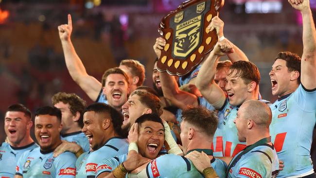 BRISBANE, AUSTRALIA - JULY 17:  Blues players celebrate with the State of Origin Shield after winning the series 2-1 after game three of the 2024 Men's State of Origin series between Queensland Maroons and New South Wales Blues at Suncorp Stadium on July 17, 2024 in Brisbane, Australia. (Photo by Chris Hyde/Getty Images)