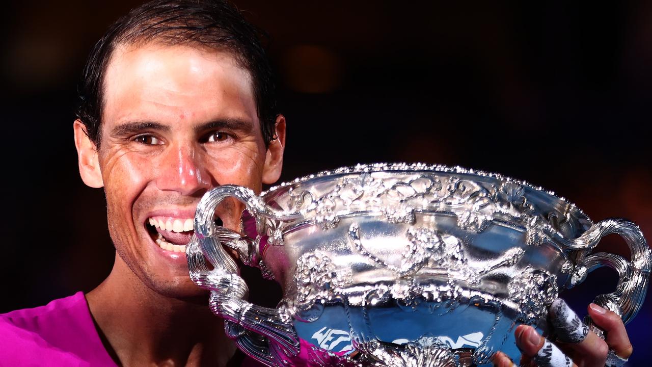 Rafael Nadal bites the Norman Brookes Challenge Cup as he celebrates his 21st grand slam win. (Photo by Clive Brunskill/Getty Images)