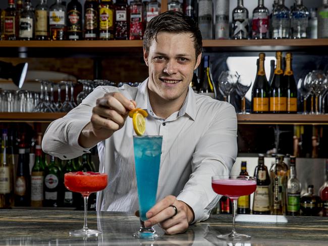 Head Bartender Luke Baericke putting the final touches to a Long Island Blue cocktail. Picture: Jerad Williams