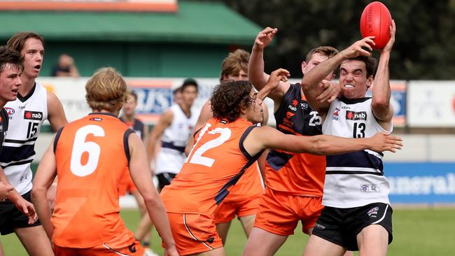 Sam Philp surrounded by GWS Academy opponents.