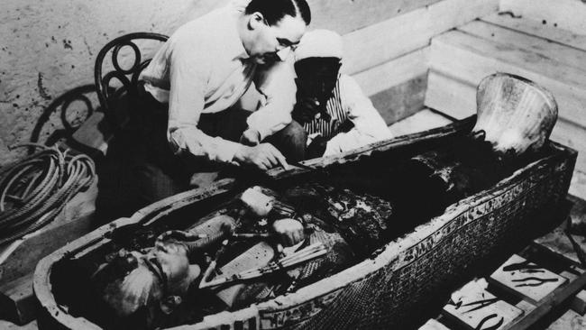 Archeologist Howard Carter examines the tomb of King Tutankhamun. Picture: AP