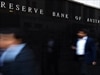 Pedestrians walk past the Reserve Bank of Australia