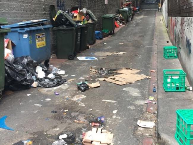 Rubbish overflows from dumpsters in Normanby Lane, central Melbourne. Picture: Snap Send Solve<br/>