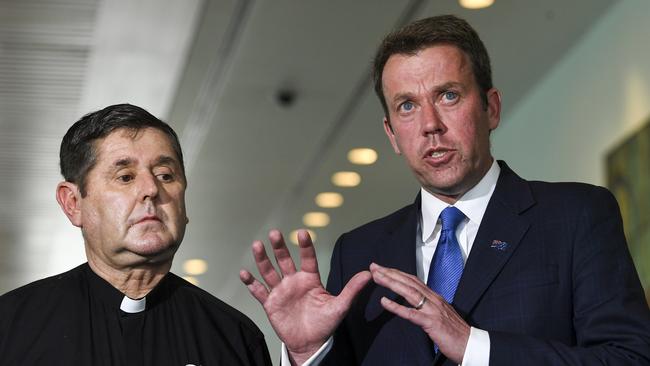 Federal Education Minister Dan Tehan with Father Chris Riley whose Youth Off The Streets charity operated special assistance to schools across NSW until changes were made to the way money was distributed. Picture: AAP