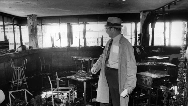 Police Inspector L Bardwell of the CIB Scientific Section inspects the damage at the Whiskey Au-Go-Go nightclub in Fortitude Valley, destroyed after a firebomb attack which killed 15 people.