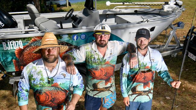 Reeling Veterans Queensland president Michael King with secretary Steve Lillie and vice president Scot Ruehland with a boat donated by a veteran at the Townsville Barra Fun Park. Picture: Evan Morgan