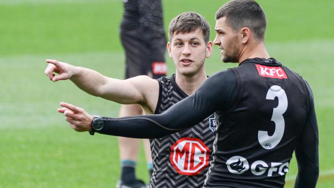 Zac Butters, left, speaks to Ryan Burton at Port Adelaide training. Picture: Brenton Edwards