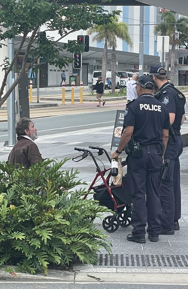 Police officers confiscating Mr Meskanen’s (left) wine. Another man’s bottle was also taken. Picture: Sam Stolz