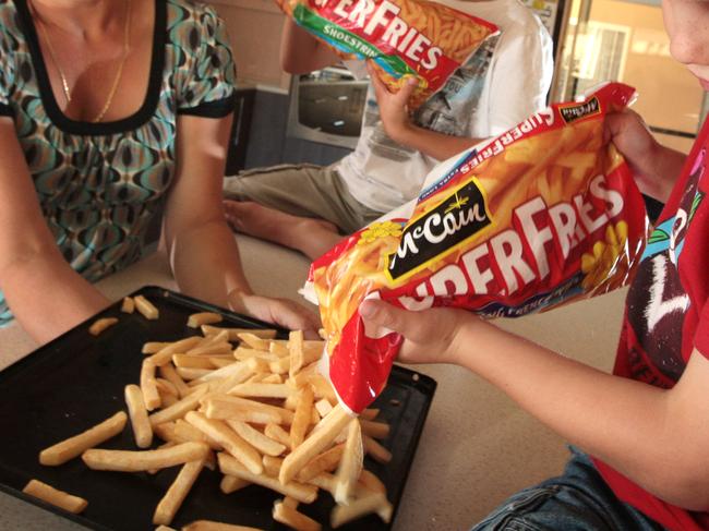 Frozen fries made from imported potatoes. Regular chip eaters, Aiden, 8, and Brodie Stevenson, 6, from Henley Beach South with their mum Sonya, and McCain frozen french fries.