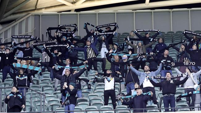 Port Adelaide fans stand for Never Tear Us Apart during the Round 2 Showdown, the last AFL game at the Oval. Picture: Sarah Reed