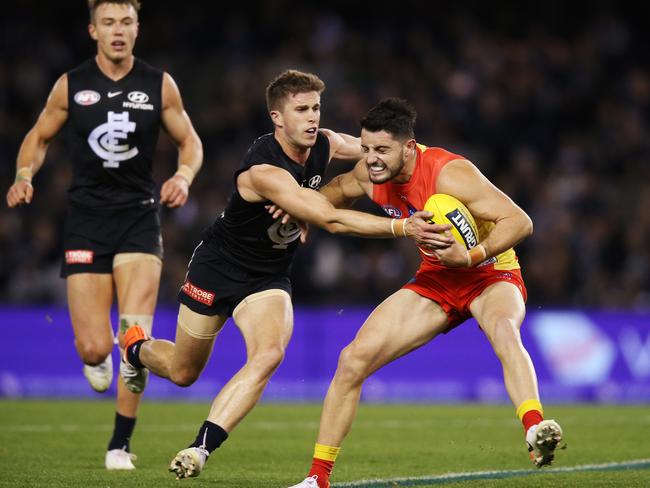 Marc Murphy of the Blues tackles Brayden Fiorini of the Suns during the round 18 AFL match between the Carlton Blues and the Gold Coast Suns at Marvel Stadium on July 20, 2019 in Melbourne, Australia. (Photo by Michael Dodge/Getty Images)