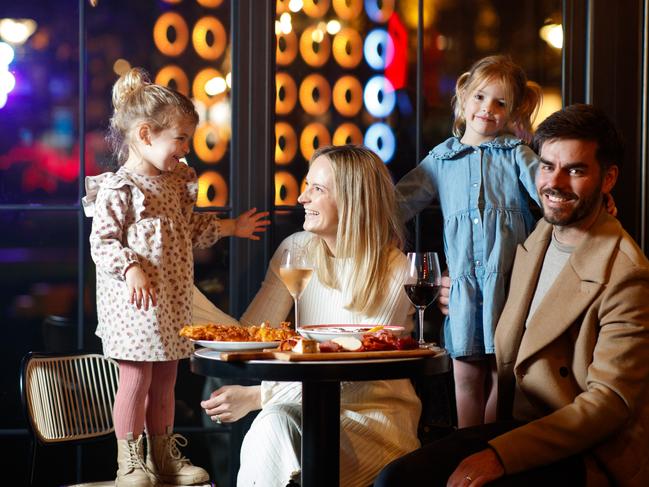 Brooke and Tom Bridges with their children Winnie (left) and Isabel enjoying Lumen at University of Adelaide, as part of Illuminate Adelaide. Picture Matt Turner.